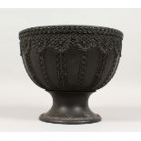 A LARGE WEDGWOOD BLACK BASALT CIRCULAR FRUIT BOWL, the sides with lattice type panels and