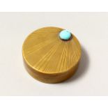 A CIRCULAR BRASS AND TURQUOISE SNUFF BOX. 1.75ins diameter.