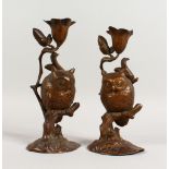 A GOOD PAIR OF LATE 19TH CENTURY CAST BRONZED SPELTER CANDLESTICKS, modelled as owls seated on a