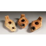 THREE ROMAN TERRACOTTA OIL LAMPS.