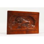 A SMALL FRUITWOOD PLAQUE, carved with a lion and Latin text. 7ins x 5ins.