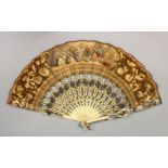 A GOOD 18TH CENTURY FRENCH IVORY AND PAPER FAN, painted with courtiers in a landscape. 18ins open.