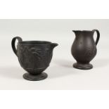 A WEDGWOOD BLACK BASALT MILK JUG, the side with dancing ladies, Impressed WEDGWOOD, 3.5ins high, and