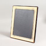 A LARGE SILVER RECTANGULAR PHOTOGRAPH FRAME. 11.5ins x 10ins.