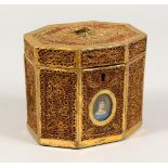 A GEORGE III ROLLED GILDED PAPER TEA CADDY, octagonal, inset with a portrait of a young girl. 4.