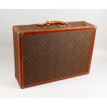 LOUIS VUITTON, a good suitcase, with monogrammed covering, stamped brass ware. 24ins x 16.5ins x