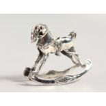 A NOVELTY SILVER ROCKING HORSE PIN CUSHION.