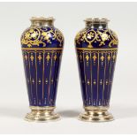 A VERY GOOD PAIR OF 19TH CENTURY FRENCH PORCELAIN VASES, with silver band, rich blue and gilt