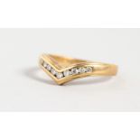 A 9CT GOLD AND DIAMOND WISHBONE RING.