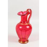 A VICTORIAN RUBY GLASS JUG. 9.5ins high.