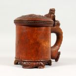 AN 18TH CENTURY SWEDISH PEG TANKARD, the lid carved with a lion and supported on three carved lion
