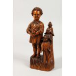 A GOOD SMALL CARVED FRUITWOOD MANICURE SET, as a figure of a boy standing next to a group of trees