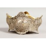A CONTINENTAL SHAPED BOWL, repousse with scrolls and cupids. 5ins wide.