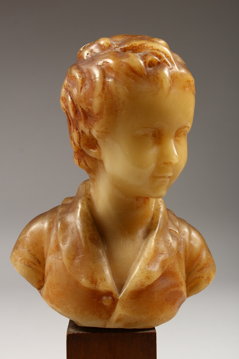 A SMALL GEORGIAN CARVED WAX BUST, head and shoulders of a young boy. 6ins high on a wooden plinth. - Image 2 of 8