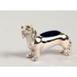 A NOVELTY SILVER DACHSHUND DOG PIN CUSHION.