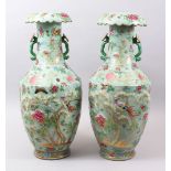 A LARGE PAIR OF 19TH CENTURY CHINESE CELADON CANTON FAMILLE ROSE PORCELAIN VASES, the body of each