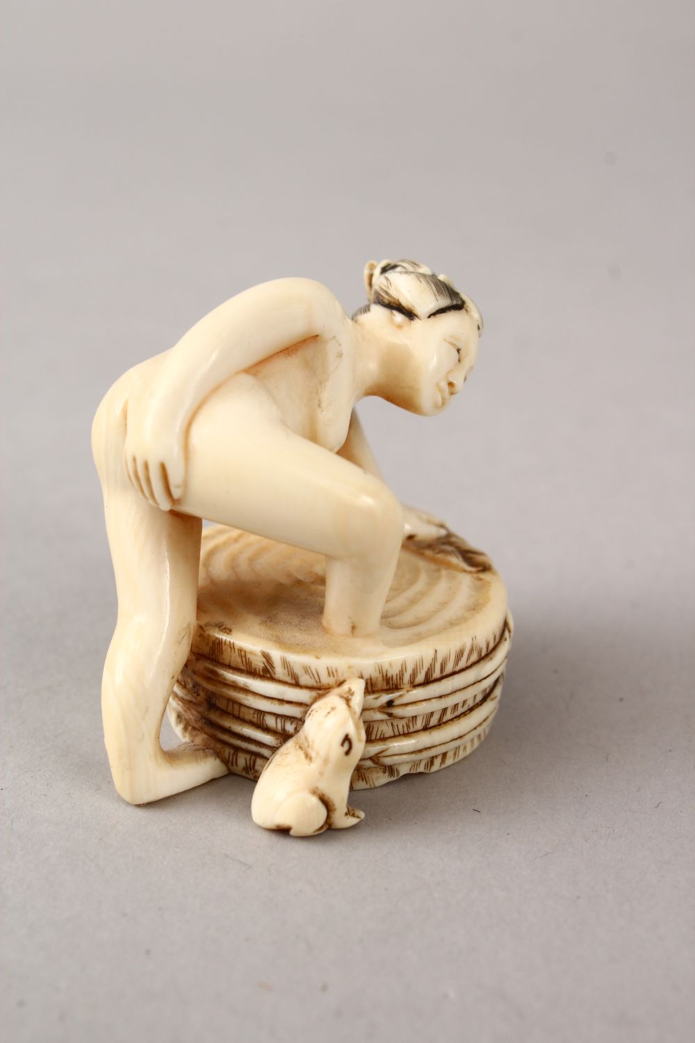 A JAPANESE LATE MEIJI PERIOD CARVED EROTIC IVORY NETUSKE & EROTIC TRIO, the netsuke of a lady over a - Image 6 of 7