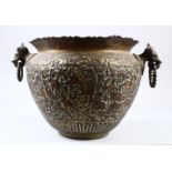 AN EARLY 20TH CENTURY INDIAN HAND CHASED BRASS BOWL, with carved decoration of animals, 36cm wide