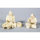 TWO GOOD JAPANESE MEIJI PERIOD CARVED IVORY OKIMONOS, of two artisans, one seated with his tool in