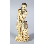 A GOOD JAPPANESE MEIJI PERIOD CARVED IVORY OKIMONO - WAYFAIRER, the man stood leaning upon a