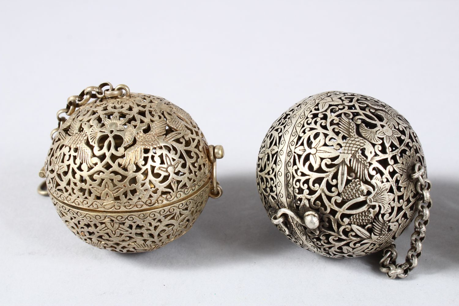 THREE CHINESE WHITE METAL PIERCED INCENSE BURNING BALLS, carved with phoenix amongst lotus, 6cm - Image 2 of 3