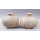 A PAIR OF UNUSUAL EARLY CHINESE BARREL SHAPED TERRACOTTA BURIAL URNS, with broad circular shaped