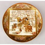A JAPANESE MEIJI PERIOD SATSUMA PLATE, decorated with a main panel depicting figures seated in a