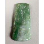A GOOD CHINESE CARVED JADE PENDANT, carved one side to depict a landscape, 6.3cm wide.