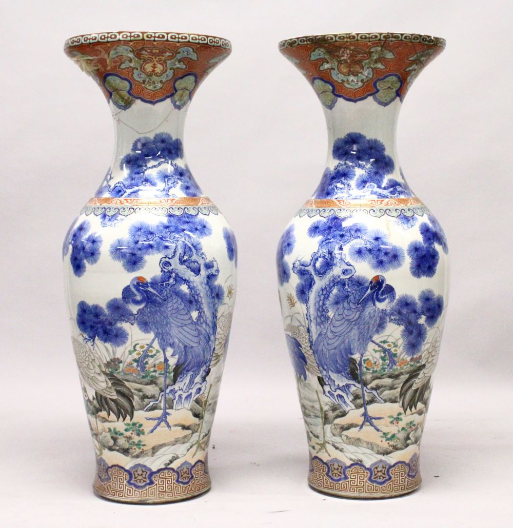 A LARGE PAIR OF JAPANESE MEIJI PERIOD BLUE AND WHITE PORCELAIN IMARI VASES, the bodyt of the vases