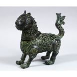 A PERSIAN BRONZE CENSER IN THE FORM OF A LION, with open work floral details, 18cm x 19.5cm.