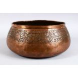 A PERSIAN / ISLAMIC COPPER BOWL, decorated with animals and flora, 14cm high x 26cm diameter.