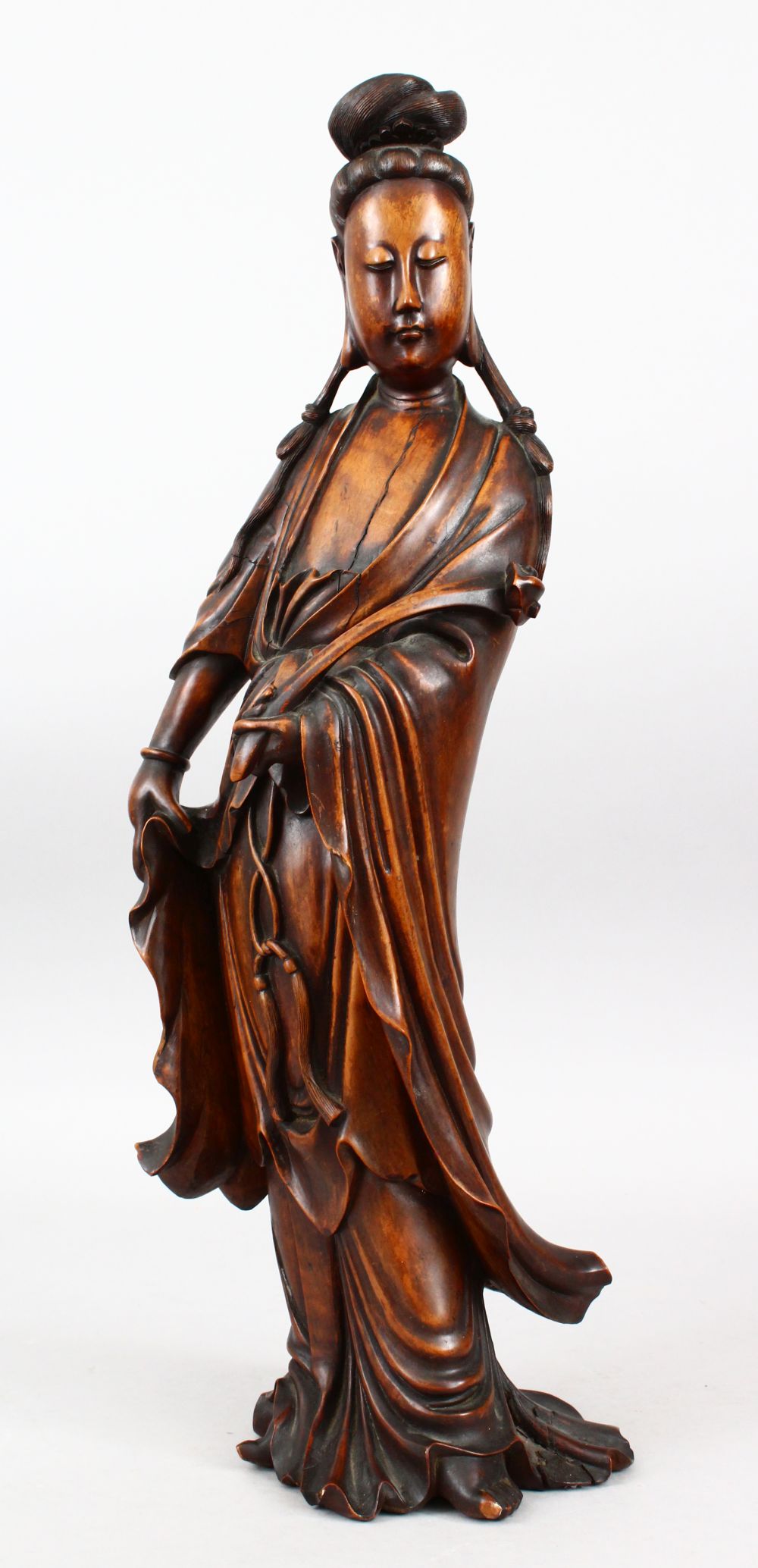 A GOOD 19TH CENTURY CHINESE CARVED HARDWOOD FIGURE OF GUANYIN, stood in traditional attire and