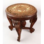 A 19TH CENTURY INDIAN CARVED WOODEN ELEPHANT TABLE, with a circular top and carved elephant head