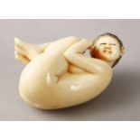 A JAPANESE LATE MEIJI PERIOD CARVED IVORY EROTIC LADY OKIMONO, depicted in an erotic pose, the