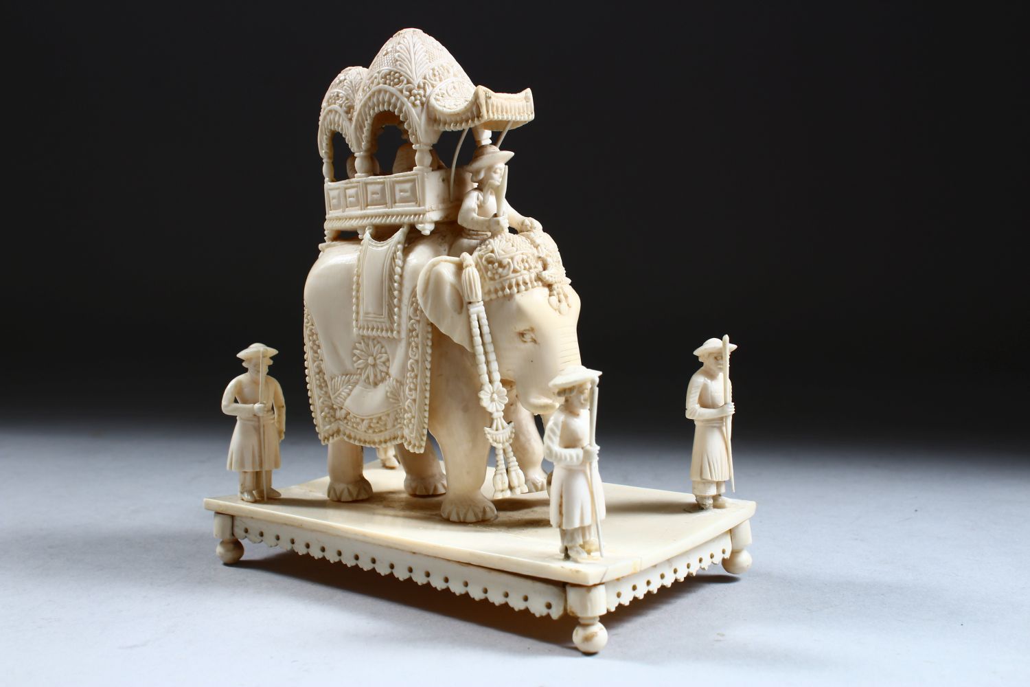 A 19TH CENTURY INDIAN CARVED IVORY FIGURE OF AN ELEPHANT AND ATTENDANTS, in a striding position with - Image 4 of 9