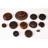 A MIXED LOT OF 19TH CENTURY CARVED AND PIERCED HARDWOOD LIDS, various shapes, sizes and styles,
