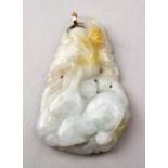 A GOOD CHINESE CARVED JADE PENDANT, carved to depict lotus and animal, with a gold metal loop, 5cm