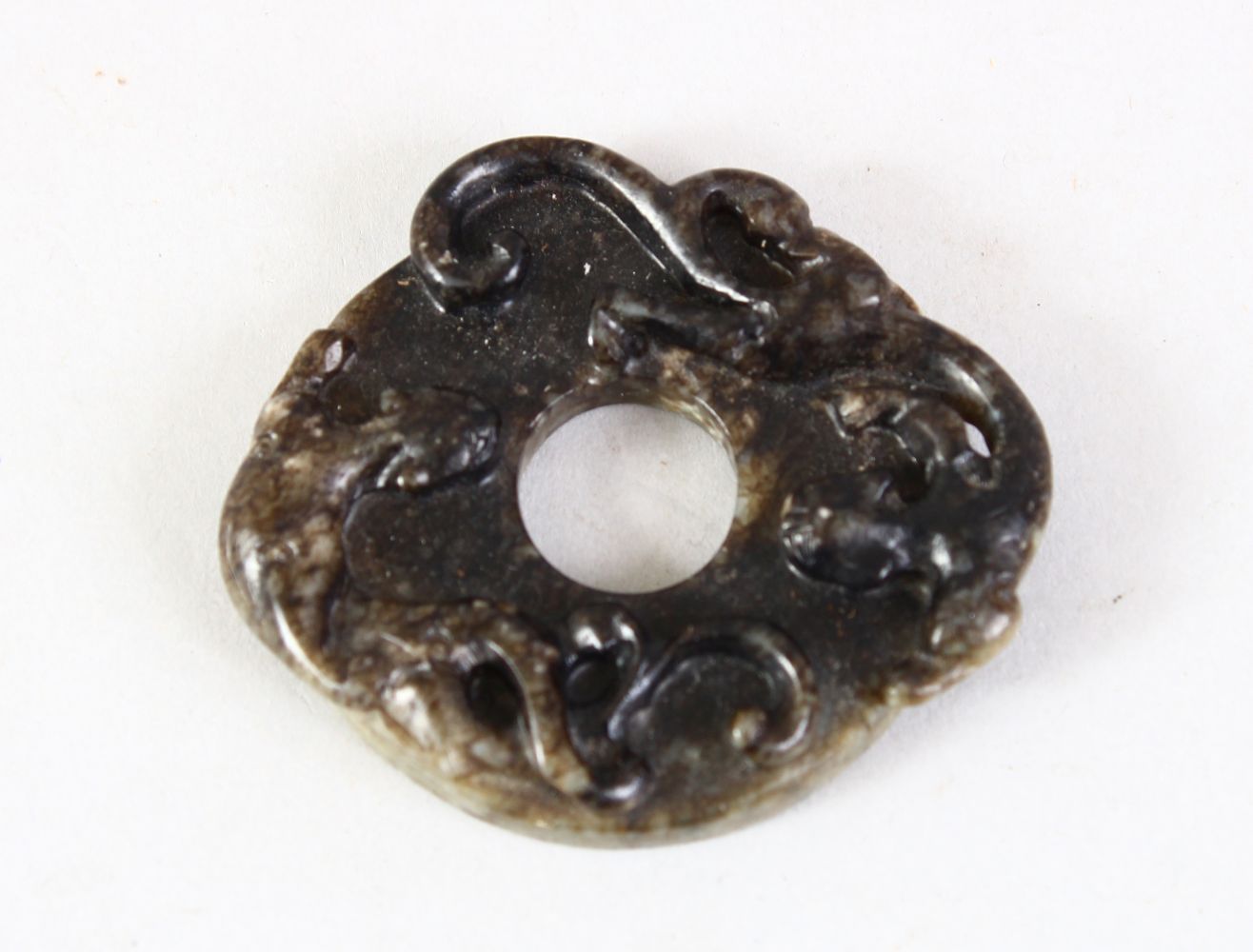 A GOOD CHINESE 19TH / 20TH CENTURY DI DISK / PENDANT / BELT ACCESSORY, carved with two chi long, 5.