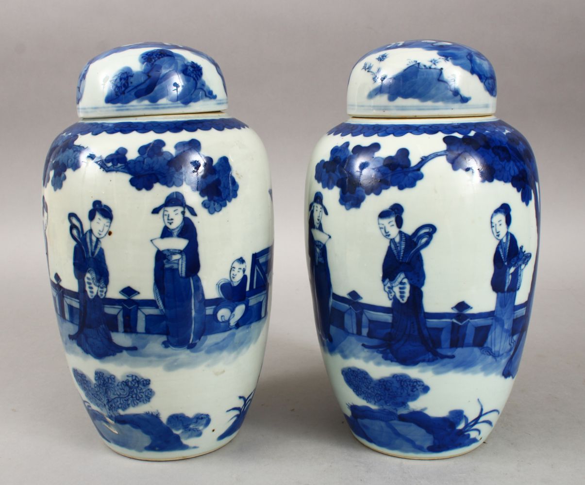 A PAIR OF 19TH CENTURY CHINESE BLUE & WHITE PORCELAIN JARS & COVERS, decorated with scenes of