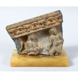 A GOOD EARLY GANDHARA ARCHITECTURAL FRAGMENT, mounted upon a stone base, 11.5cm high, 11.5cm