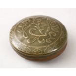 A GOOD CHINESE LONQUAN CELADON MOULDED PORCELAIN BOX & COVER, with moulded lotus decoration, 11cm