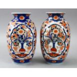 A PAIR OF JAPANESE MEIJI PERIOD FUKAGAWA IMARI PORCELAIN VASES, decorated in typical imari palate,