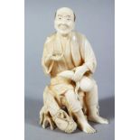 A GOOD JAPANESE MEIJI PERIOD CARVED IVORY OKIMONO - MAN DRINKING SAKE, the figure seated upon a