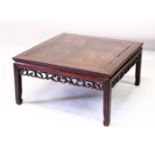 A 19TH CENTURY CHINESE CARVED HARDWOOD COFFEE TABLE, with a open carved frieze, stood upon four