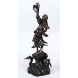 A JAPANESE MEIJI PERIOD BRONZE FIGURE OF A GOD WITH DEER AND MINOGAME, the figure stood on a