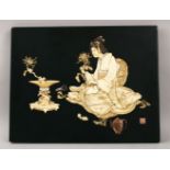 A JAPANESE MEIJI PERIOD CARVED IVORY INLAID PANEL OF A BIJIN GIRL ARRANGING FLORA, the panel inset