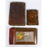 A COLLECTION OF THREE PERSIAN & ISLAMIC PAINTED & A LEATHER BOOK BINDINGS, the leather binding