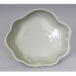 AN UNUSUAL CHINESE CELADON GLAZED PORCELAIN BRUSH WASHER, with a wavy rim, the base unglazed, 12.9 x