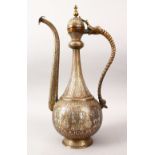 A 19TH CENTURY ISLAMIC BRONZE AND SILVER INLAID WINE EWER, with bands of calligraphy and panels of