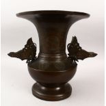 A GOOD JAPANESE MEIJI PERIOD BRONZE TWIN HANDLE VASE, the vase with carved decoration depicting